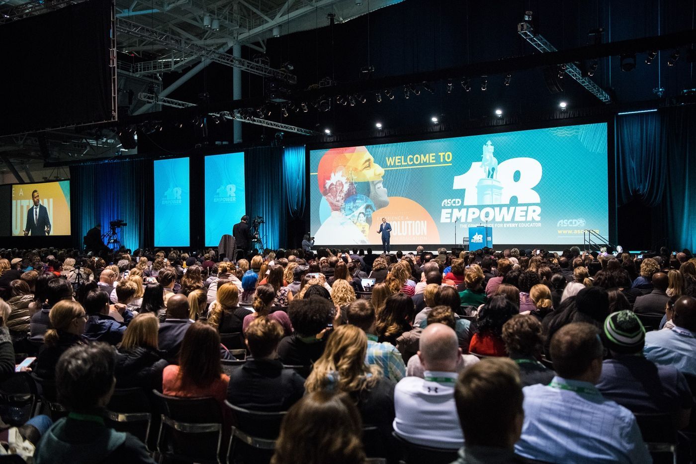 Dr. Scott on stage at an educator conference