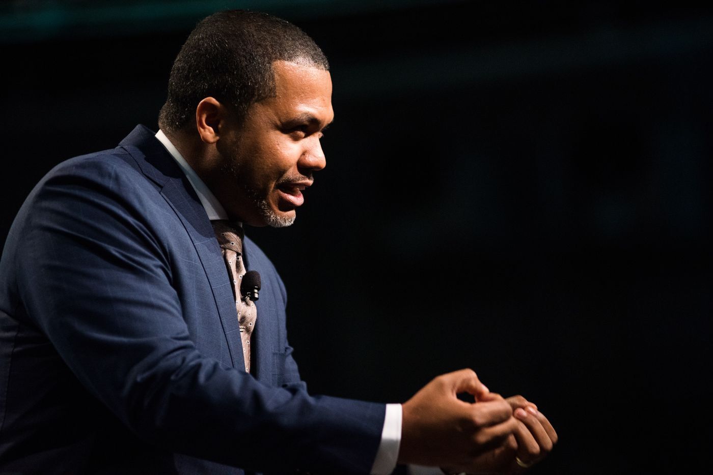 Dr. Manny Scott speaking from a podium